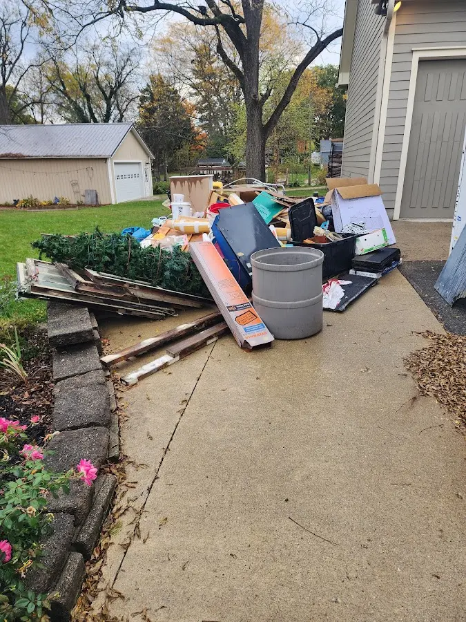 Dumpster being loaded with debris for Demolition Dumpster Rental in New Milford